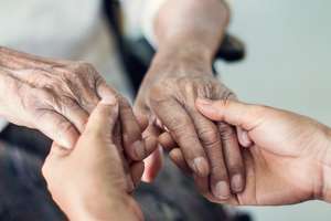 Close Up Hands Of Helping Hands Elderly Home Care. Mother And Daughter. Mental Health And Elderly Care Concept