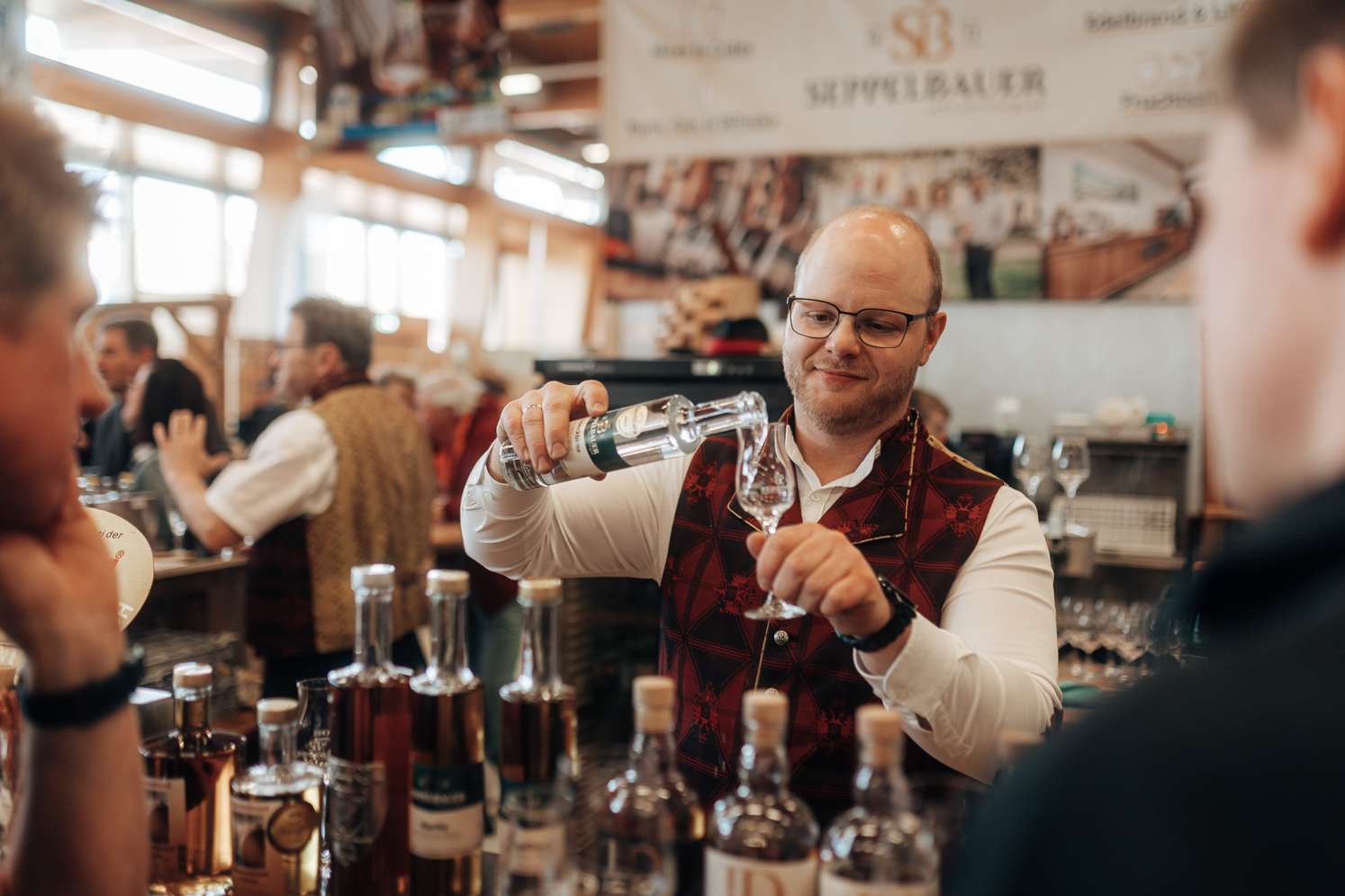 Mann schenkt Getränk in ein Glas ein