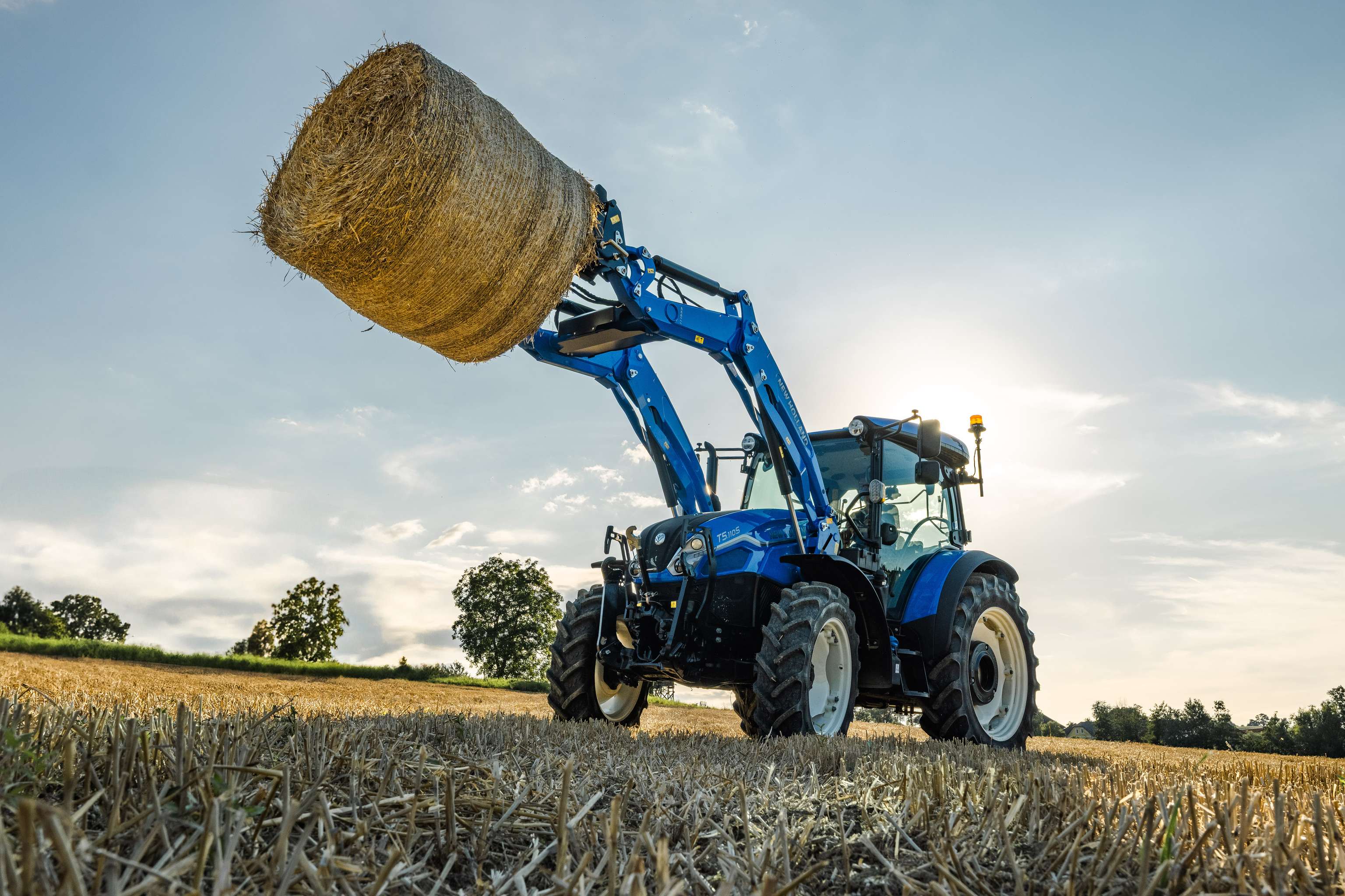 Traktor mit Fontlader auf dem Feld