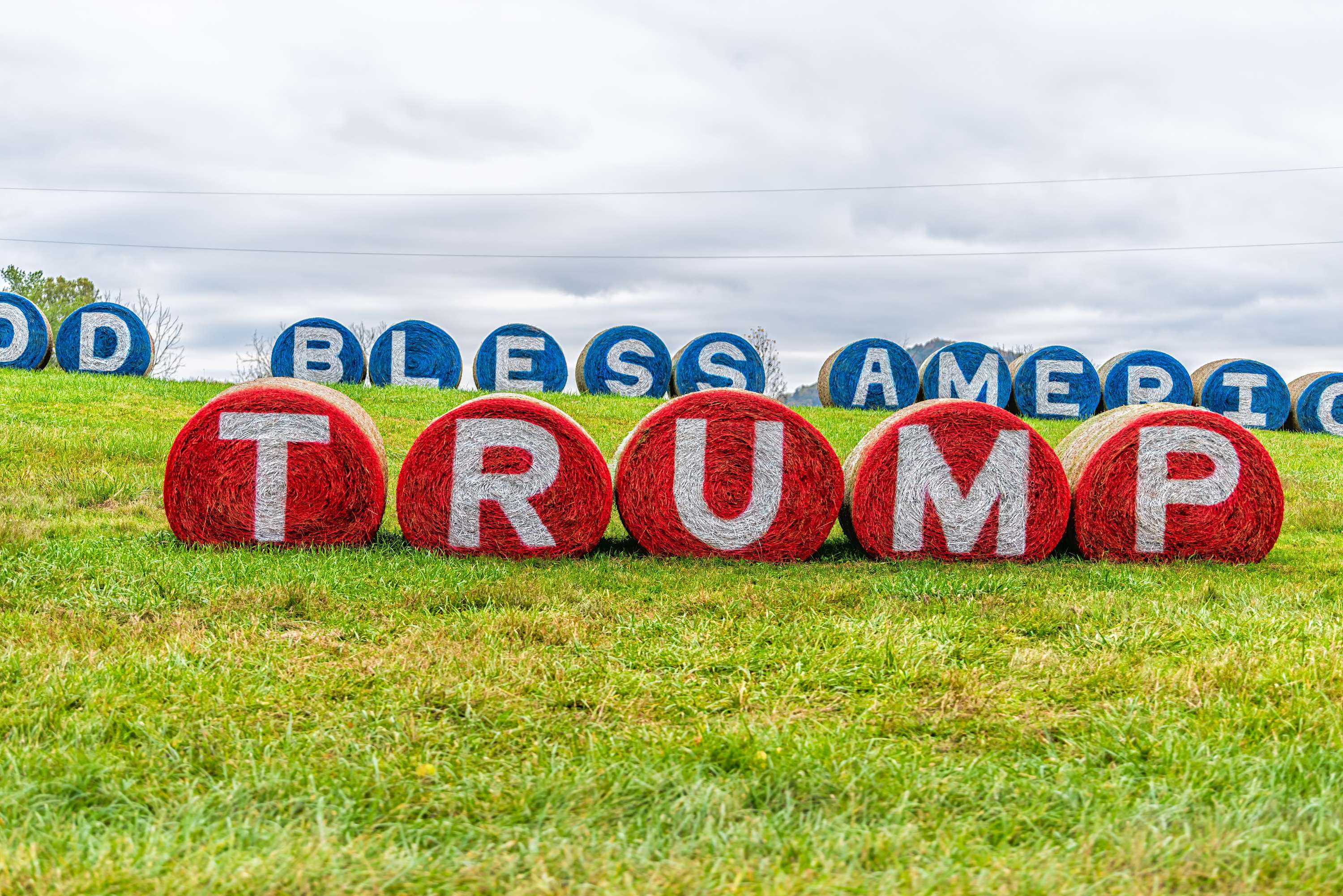 Rote und blaue Heuballen mit Schriftzügen "Trump" und "God bless America"