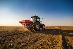 Farmer Fertilizing Arable Land With Nitrogen, Phosphorus, Potassium Fertilizer