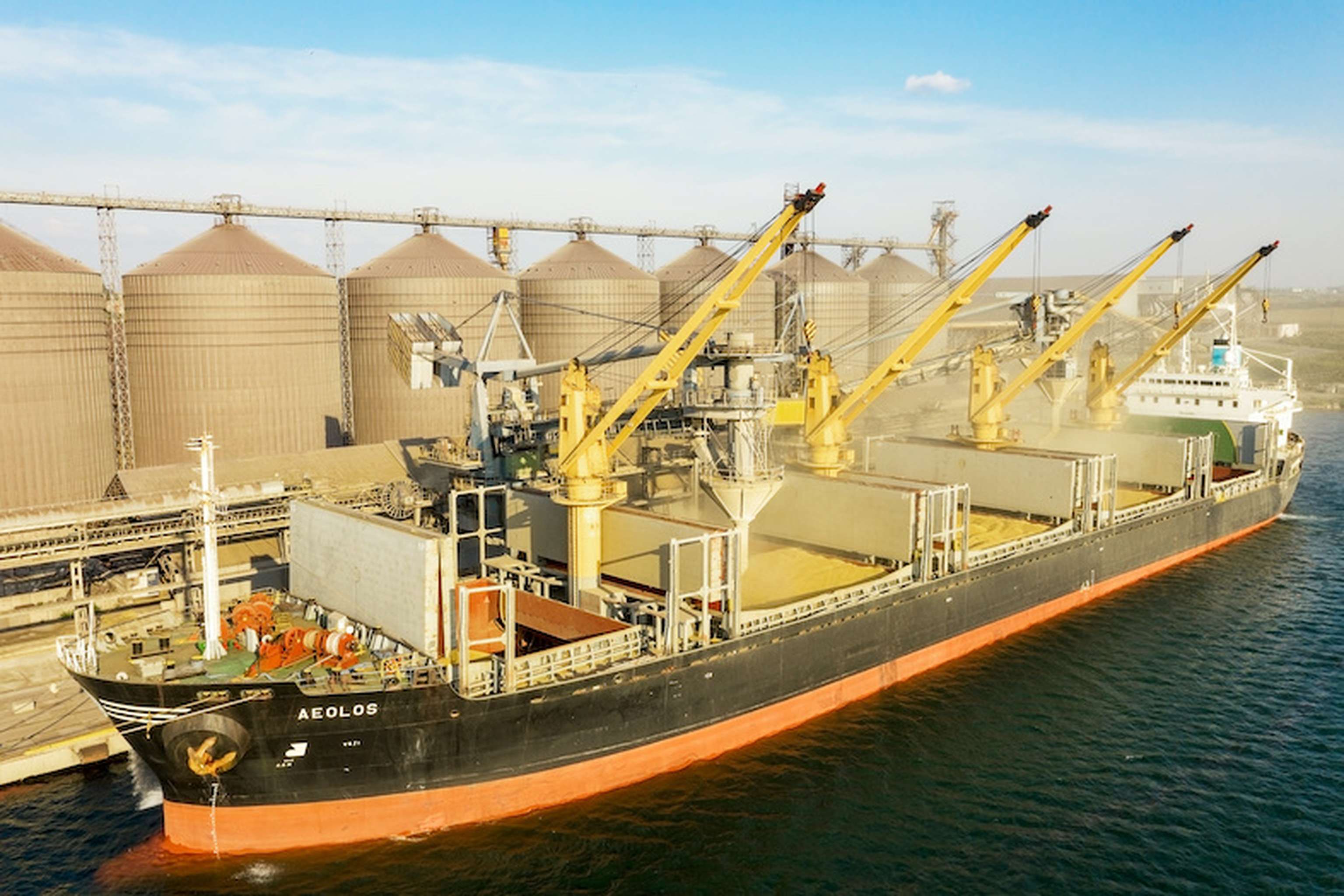 ODESSA, UKRAINE August 9, 2021: Loading Grain Into Holds Of Sea Cargo Vessel Through An Automatic Line In Seaport From Silos Of Grain Storage. Bunkering Of Dry Cargo Ship With Grain