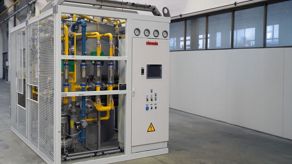 Industrial auxiliary equipment with gauges, pipes, and a control panel inside a metal framework, situated in a spacious, clean facility.