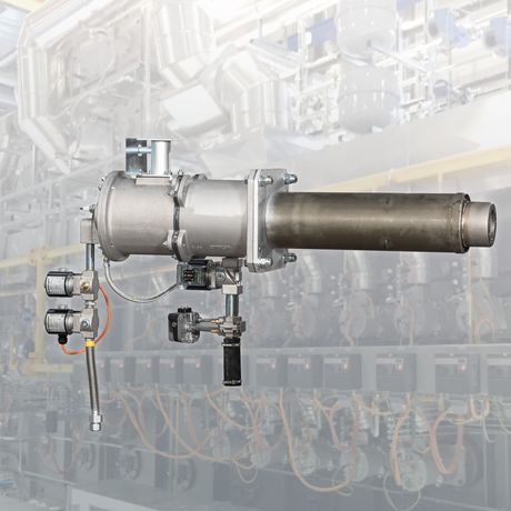 Industrial burner system with a metallic cylindrical structure, pipelines, and control valves in a factory setting.