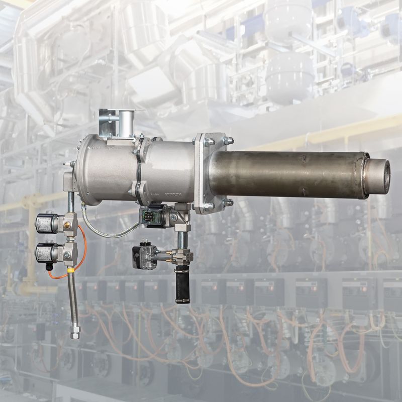 Industrial burner system with a metallic cylindrical structure, pipelines, and control valves in a factory setting.