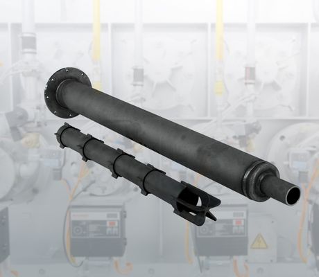 A large black industrial pipe with multiple sections and a flange against a blurred industrial background with machinery.