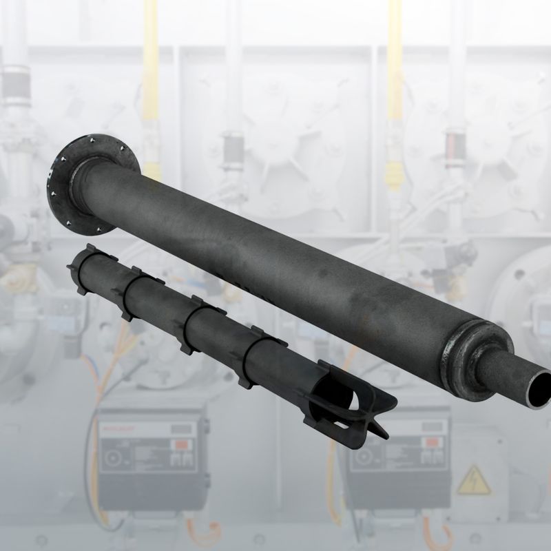 A large black industrial pipe with multiple sections and a flange against a blurred industrial background with machinery.
