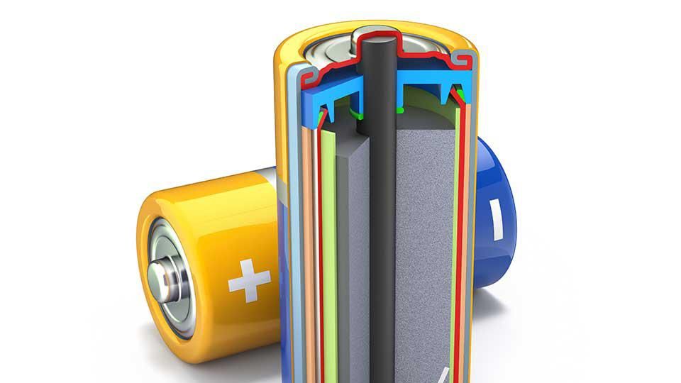 Cross-section of a battery illustrating its internal components, including layers and electrodes, next to a closed, yellow battery with visible terminals.