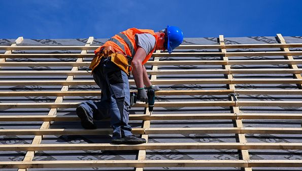 Roofer installing roof battens