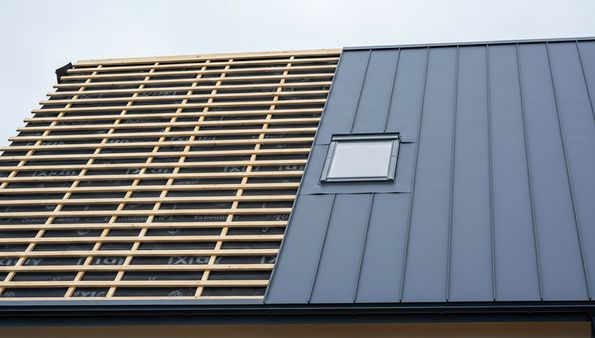 Metal roof installation with battens and standing seam panels