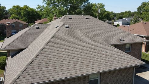 Large residential roof with aging asphalt shingles