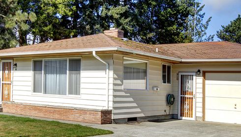 Single-story home with brown asphalt shingle roof