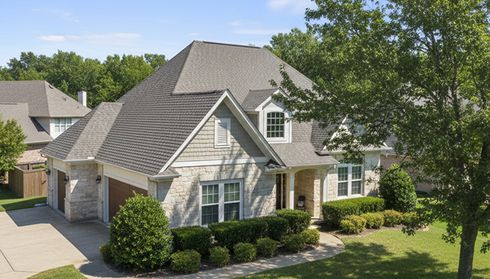 Two-story home with gray asphalt shingle roof
