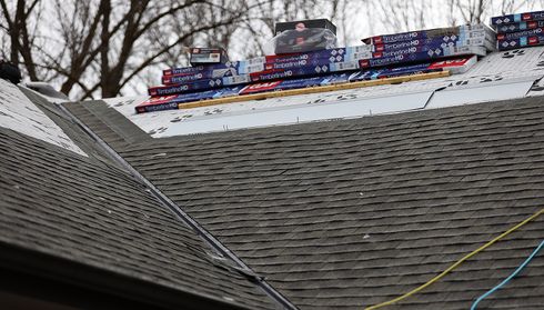 New asphalt shingles and roofing materials during roof installation