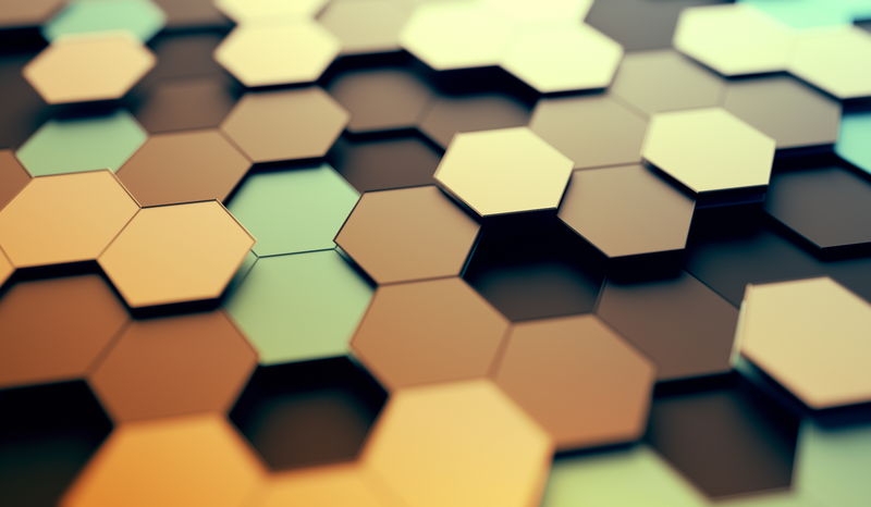 Abstract image of interlocking hexagons in varying shades of brown, green, and yellow, creating a 3D geometric pattern.