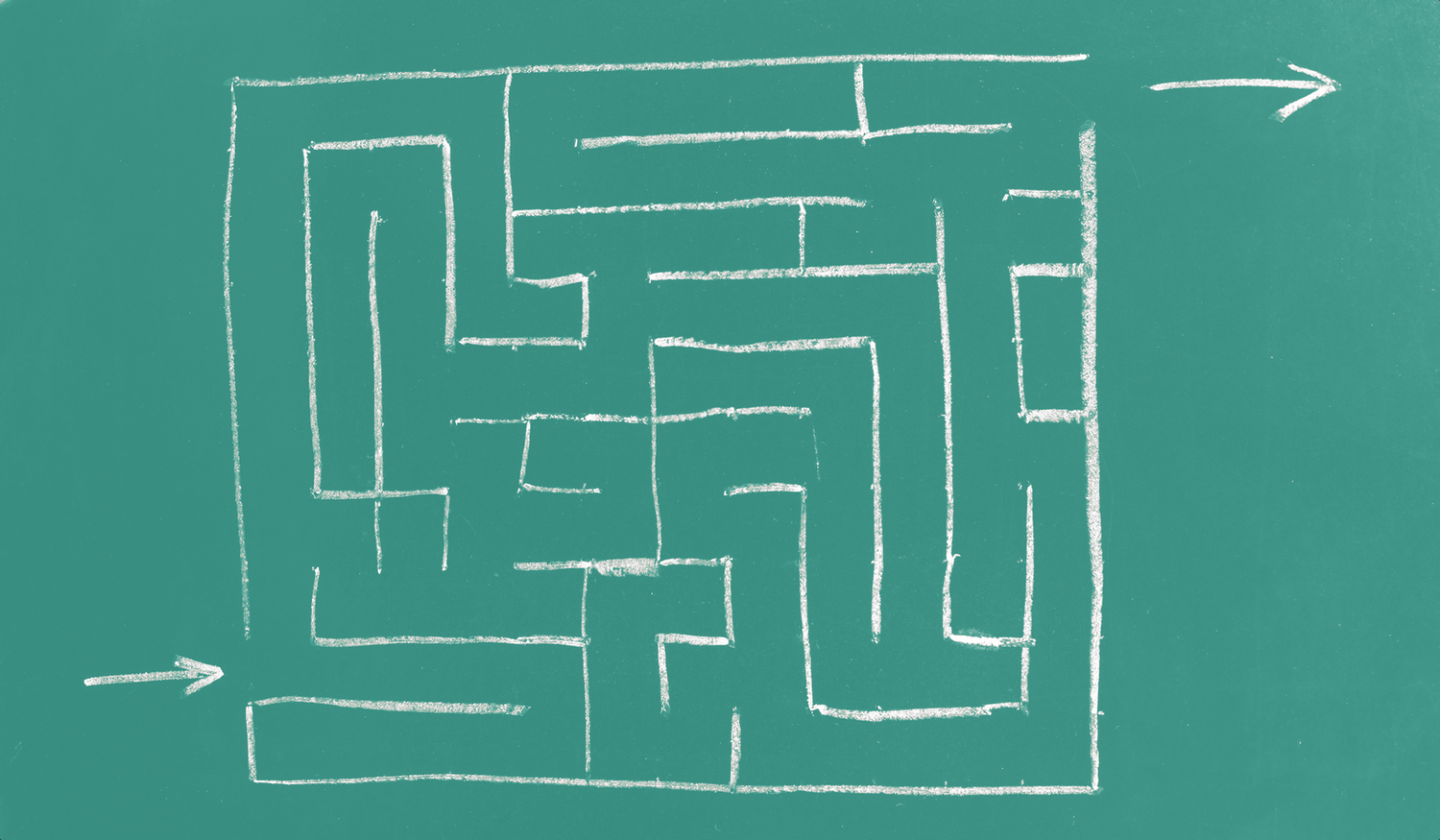 A chalk-drawn maze on a green chalkboard with an arrow pointing to the entrance and another arrow indicating the exit.