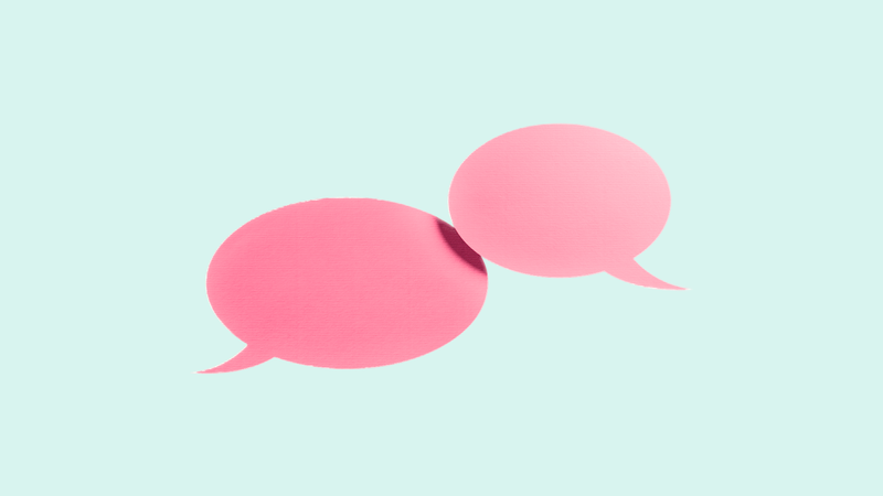 Two overlapping pink speech bubbles on a light blue background, symbolizing communication or dialogue.