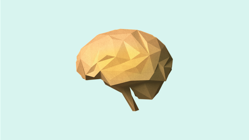 A geometric, low-poly model of a brain in gold color on a light blue background.