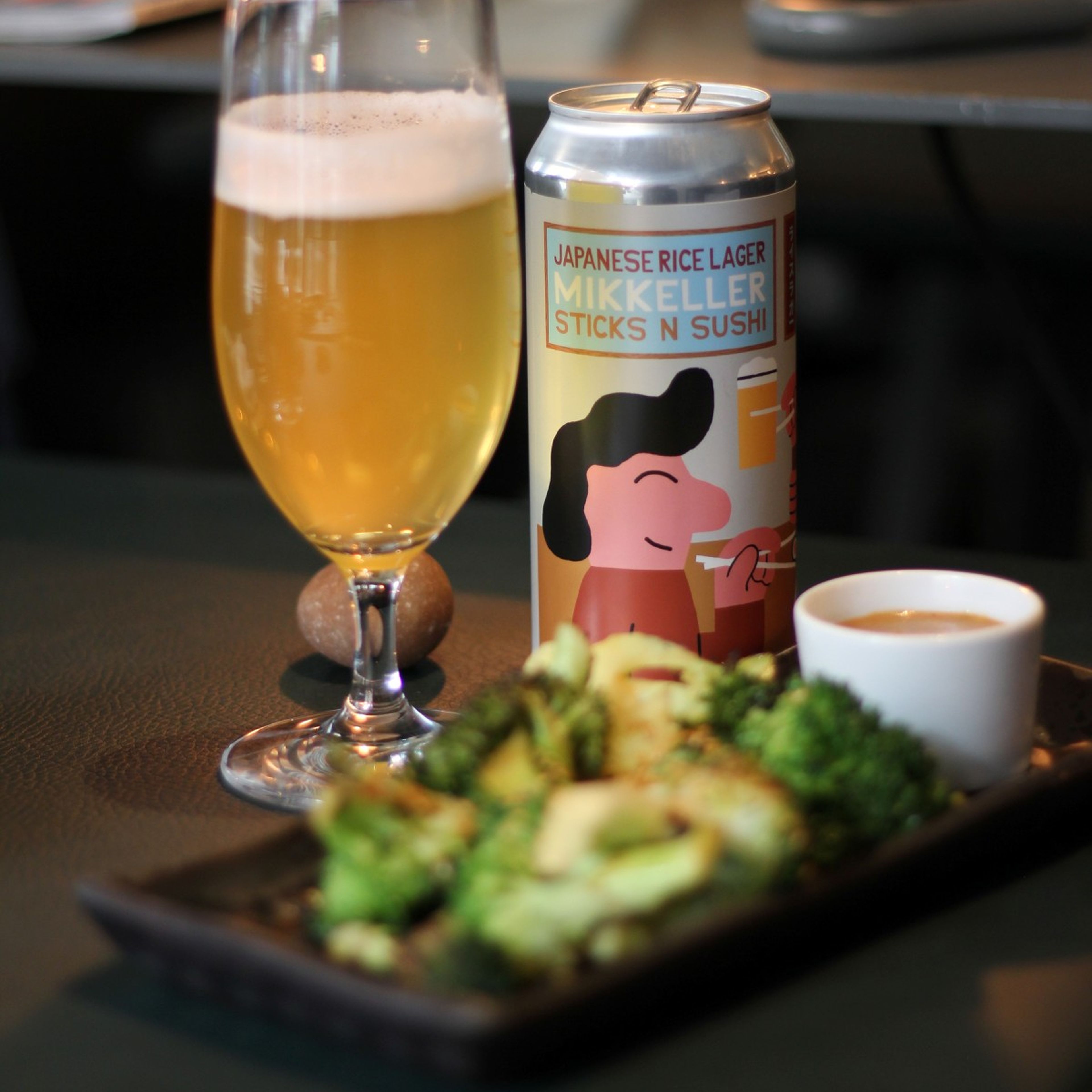 Mikkeller beer and broccoli inside a restaurant