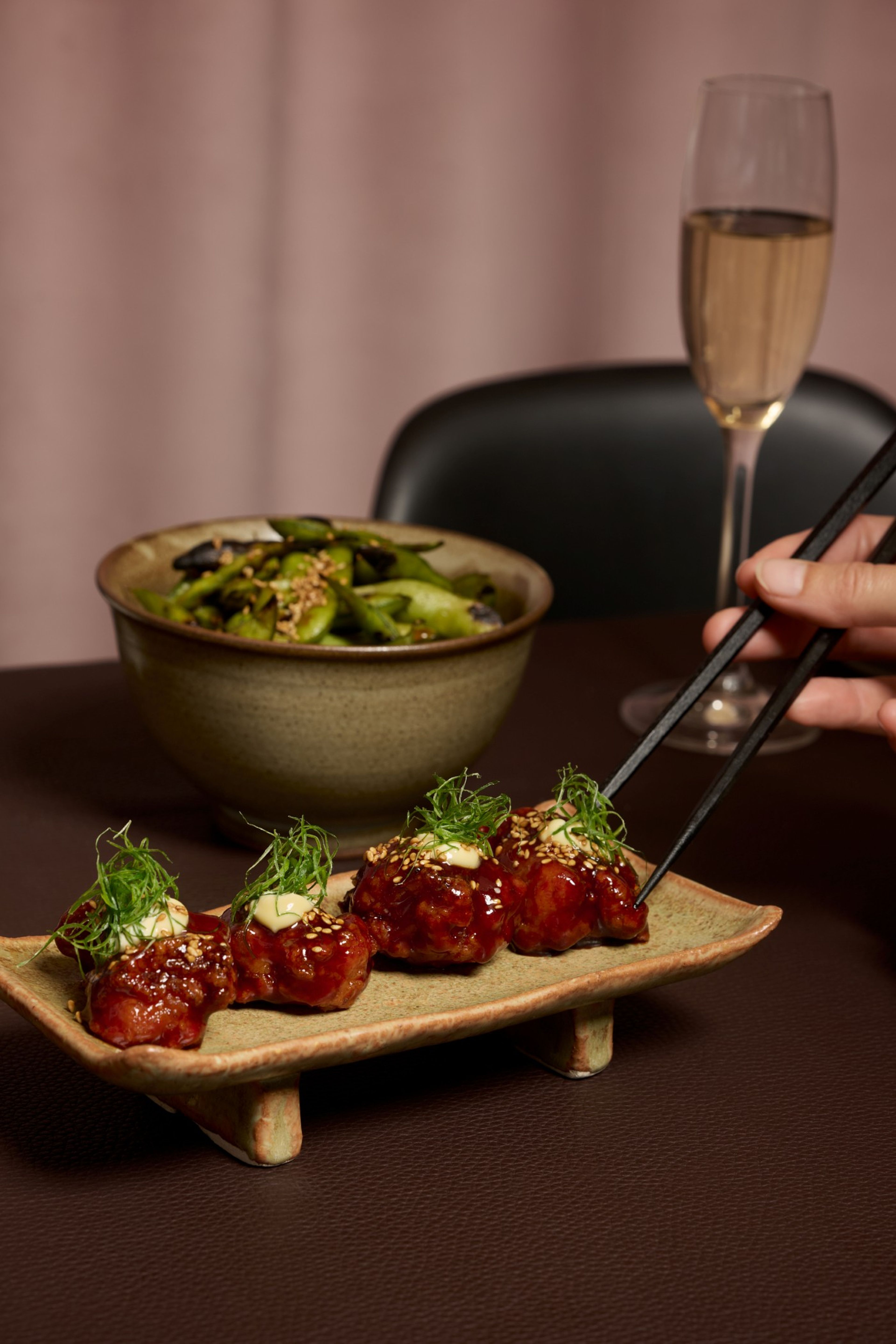 Spicy tori on table with edamame beans and bubbles