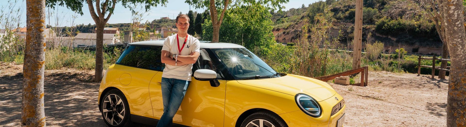 MINI Cooper SE with Beau standing on the side in Spain
