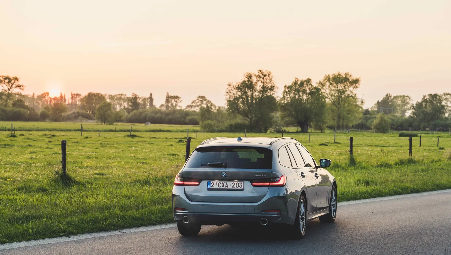 2024 BMW 320e Touring rear sunset fields grass