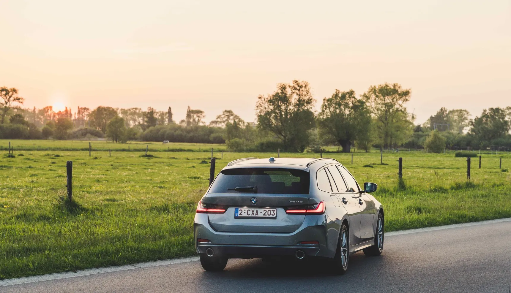 2024 BMW 320e Touring rear sunset fields grass