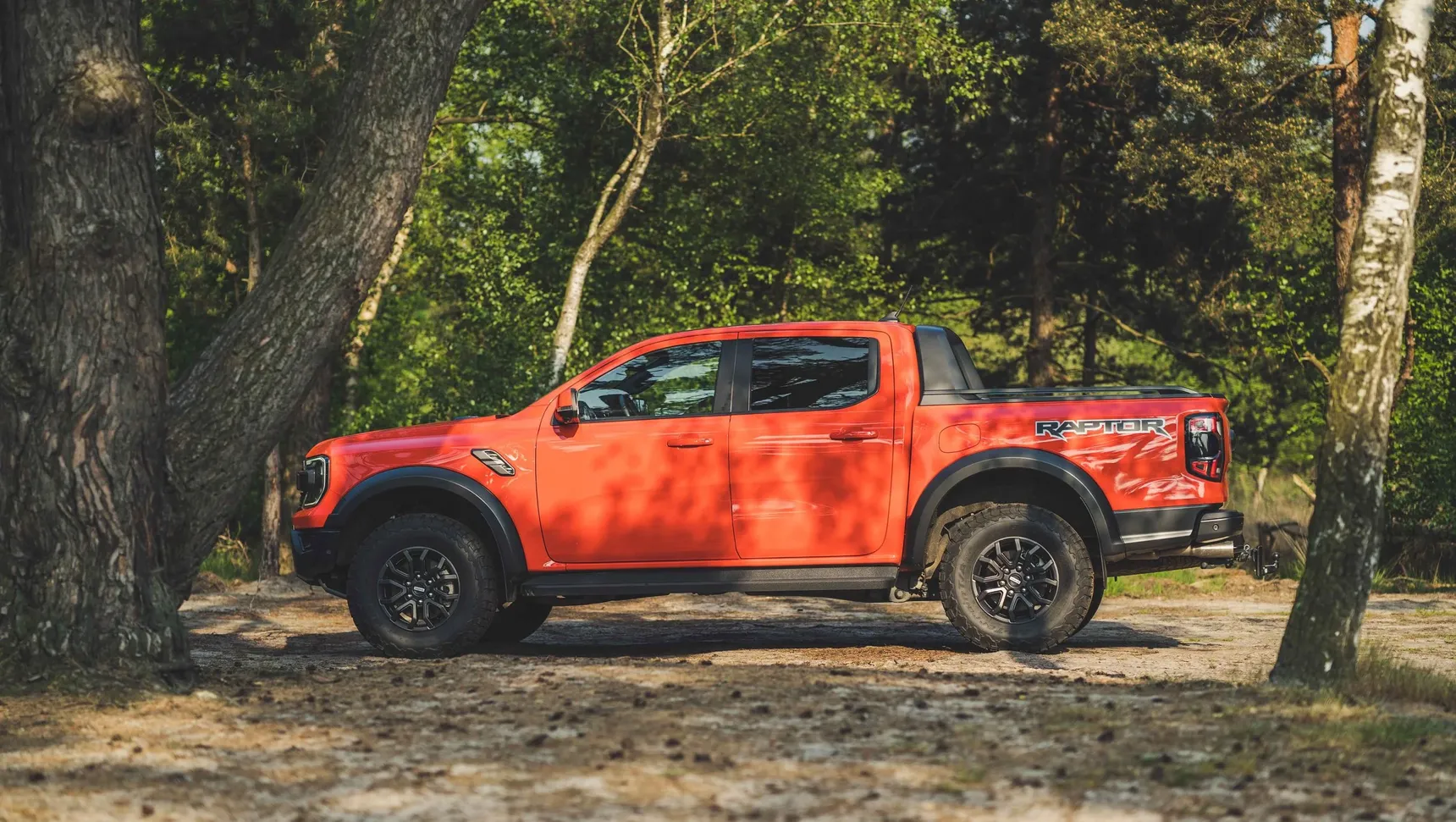 2024 Ford Ranger Raptor side profile trees forest offroad