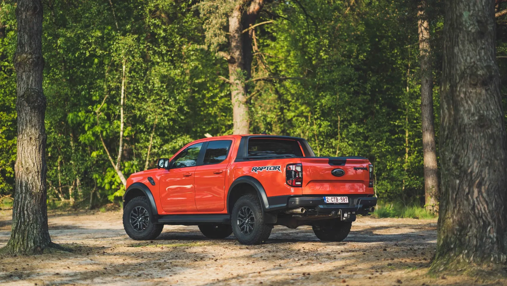 2024 Ford Ranger Raptor rear 3/4 forest trees offroad