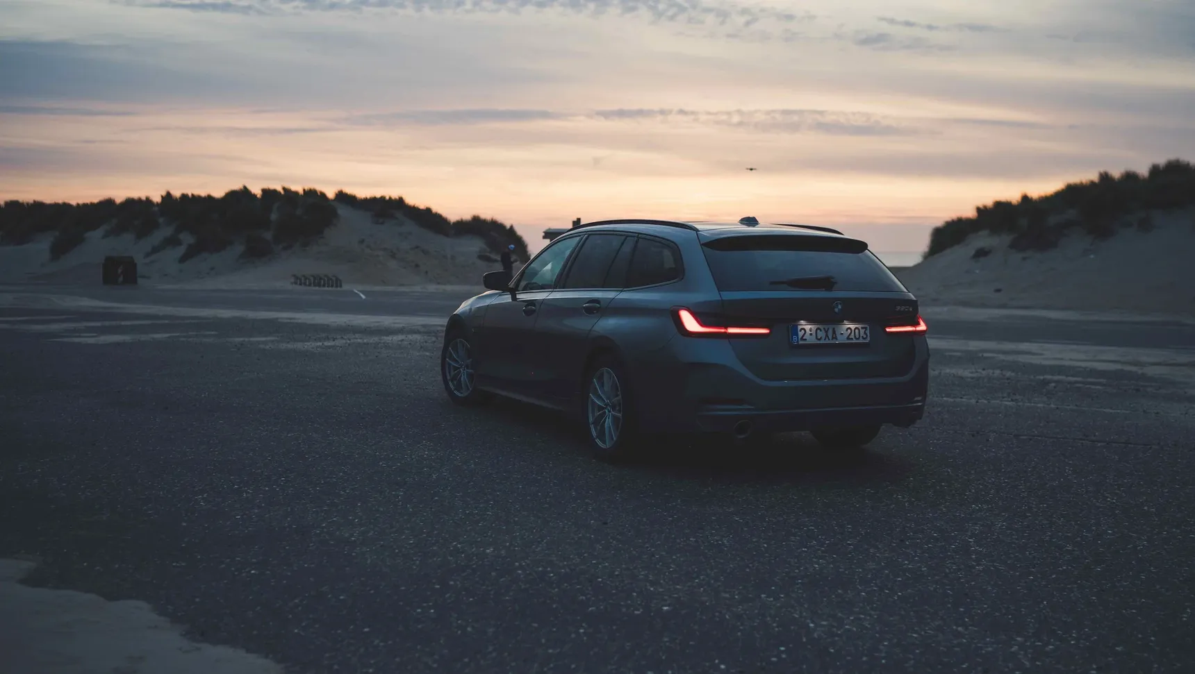 2024 BMW 320e Touring sunset beach rear 3/4