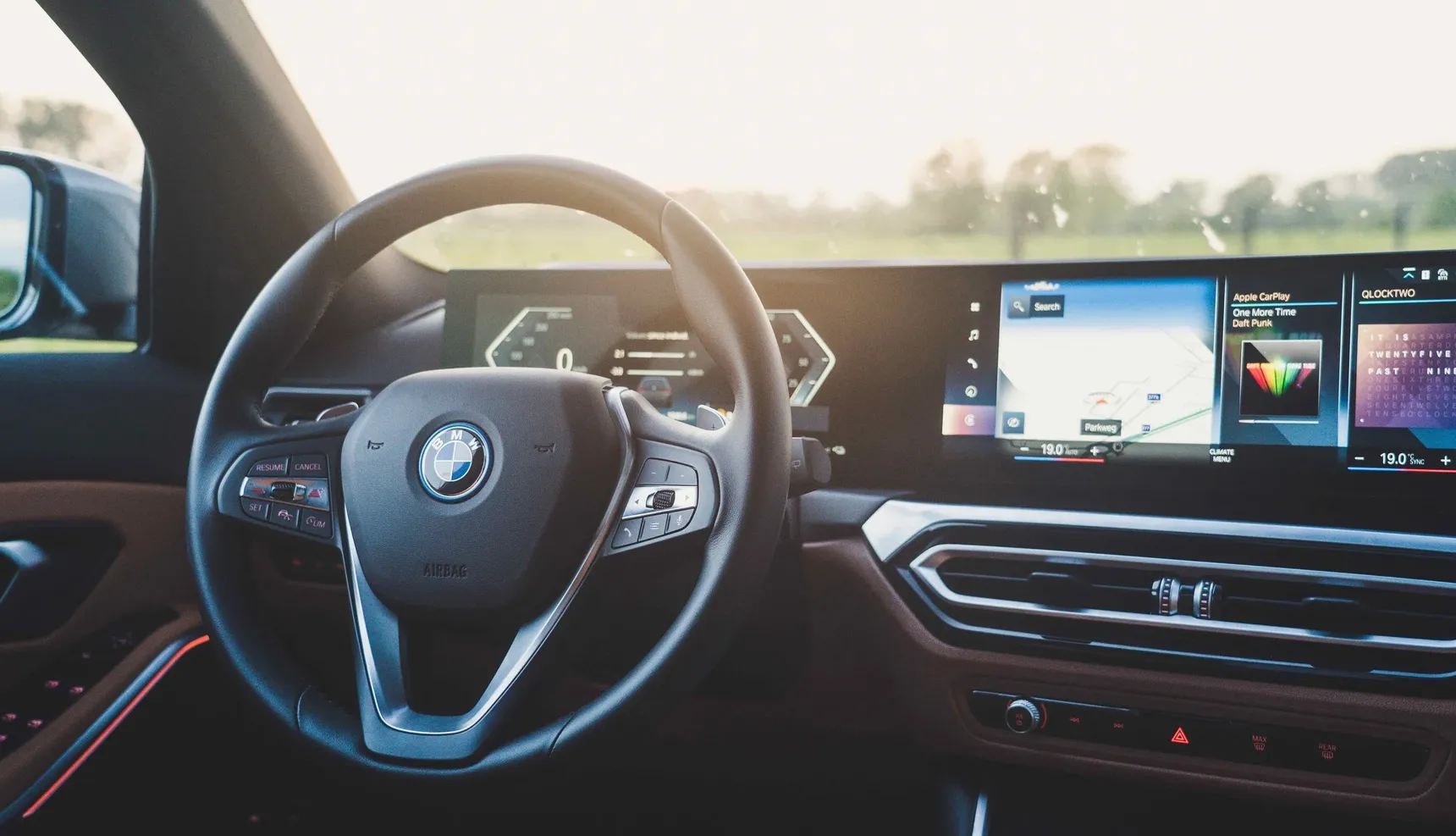 2024 BMW 320e Touring interior steering wheel sunset