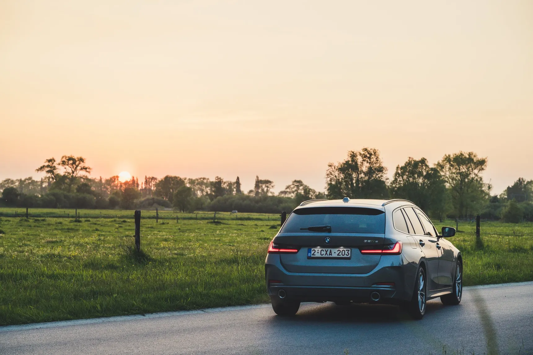 2024 BMW 320e Touring rear sunset grass fields