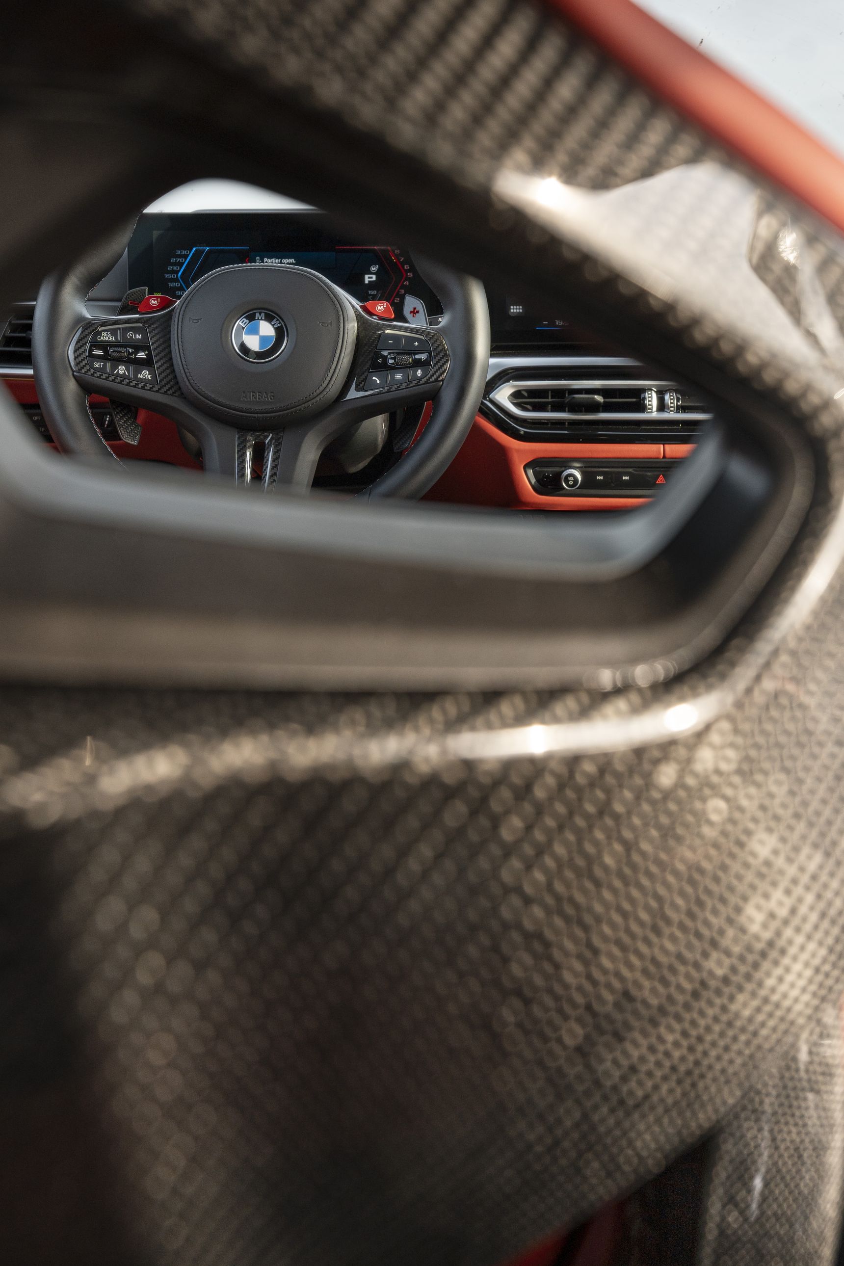 2023 BMW M3 Touring interior steering wheel through red carbon seats
