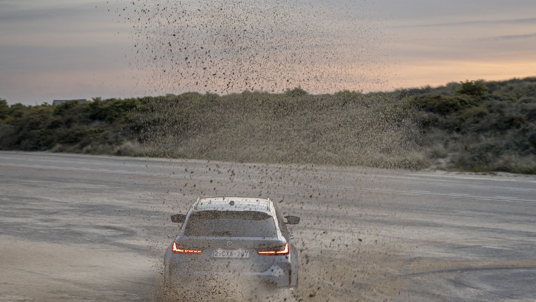 2023 BMW M3 Touring drifting sand sunset iphone background