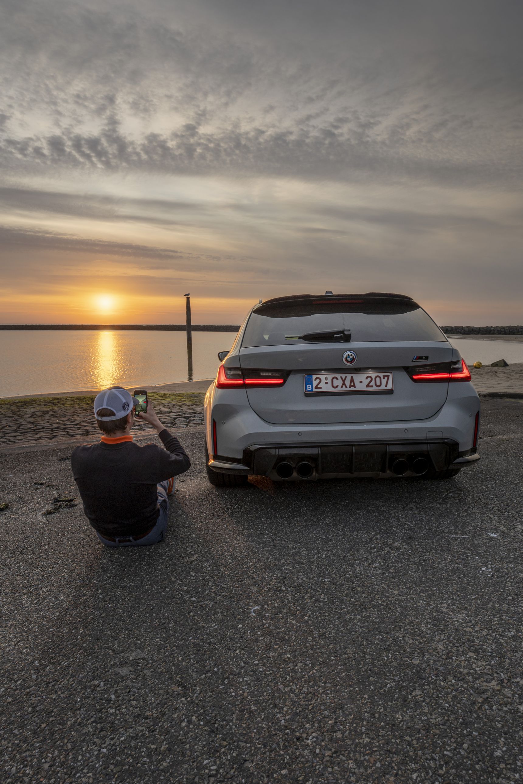 2023 BMW M3 Touring sunset dreaming rear iphone background