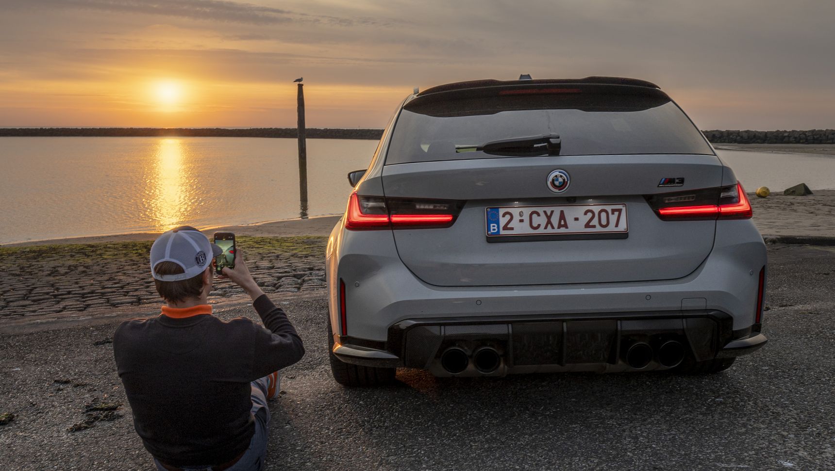 2023 BMW M3 Touring sunset dreaming rear iphone background