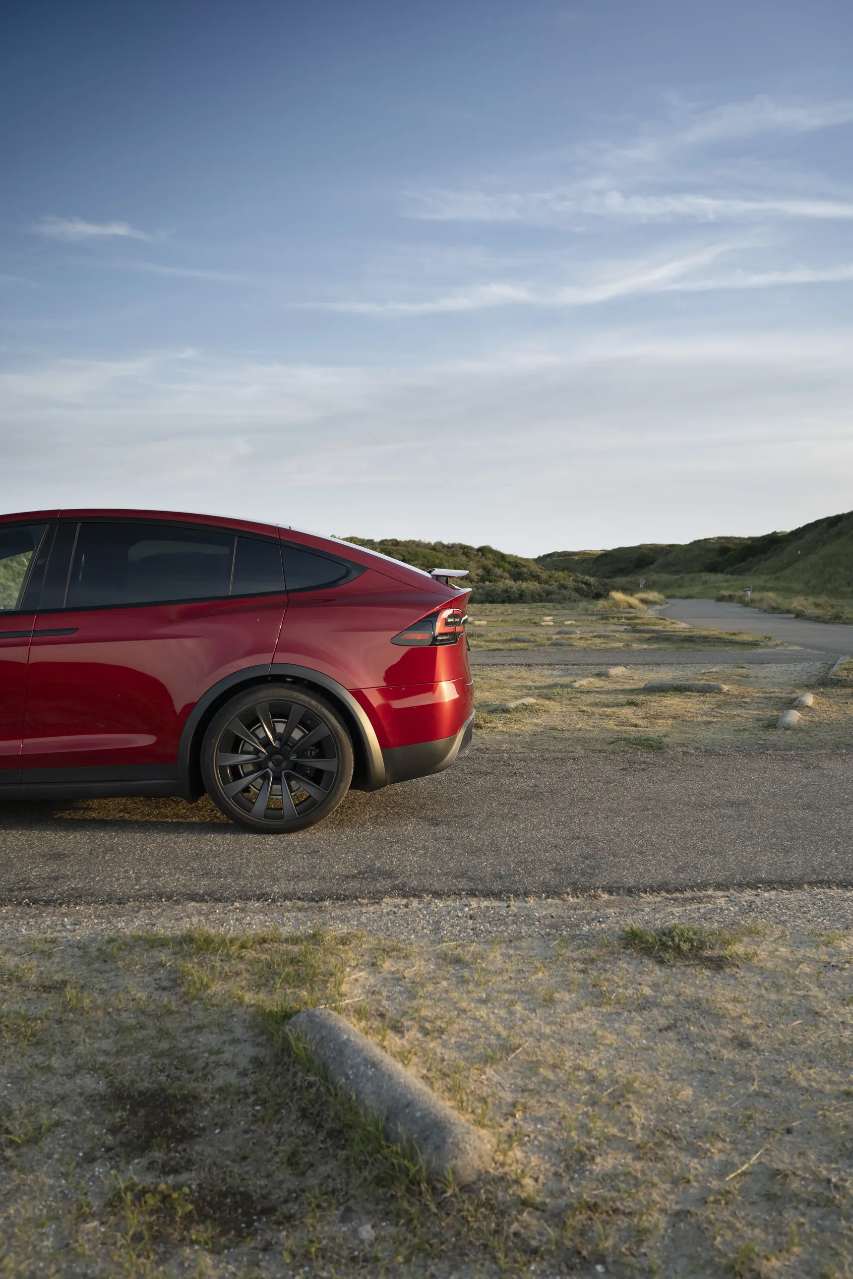 2024 Tesla Model X Long Range Red side profile iphone background