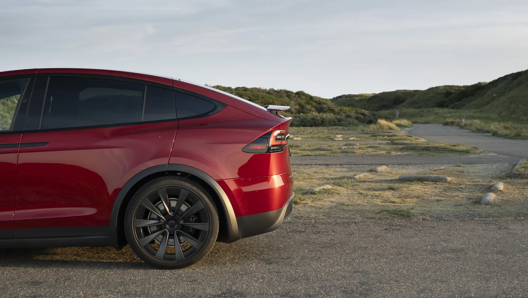 2024 Tesla Model X Long Range Red side profile iphone background