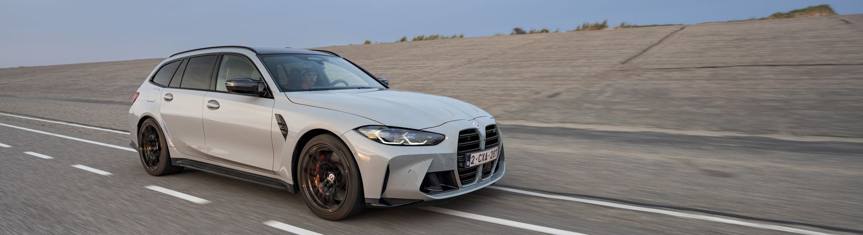 2023 BMW M3 Touring driving rolling shot side
