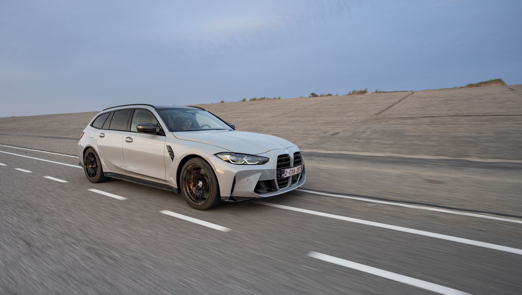 2023 BMW M3 Touring driving rolling shot side