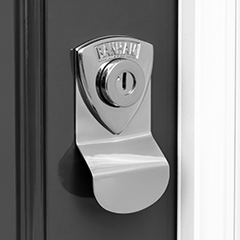 Close-up of a shiny Banham front door lock on a dark period front door
