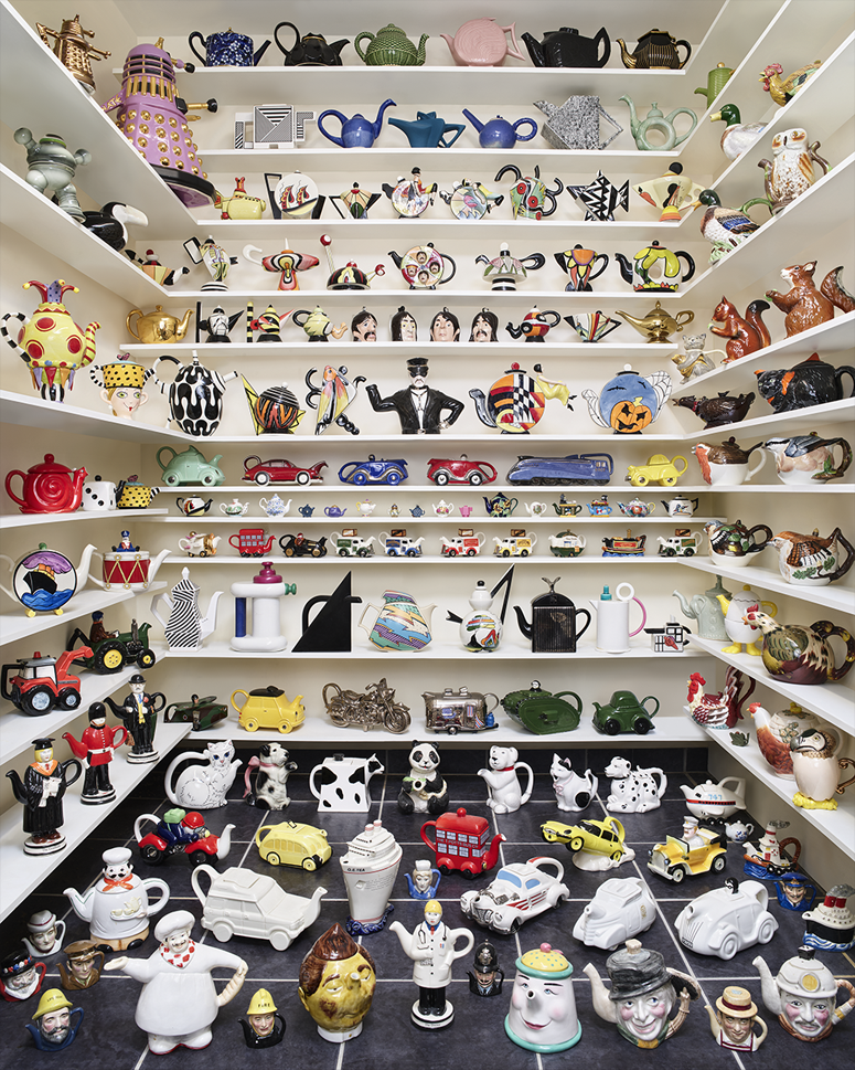 Protect What You Cherish Banham Shelves filled with a colorful and diverse collection of whimsical teapots, including animal shapes, vehicles, and creative designs.