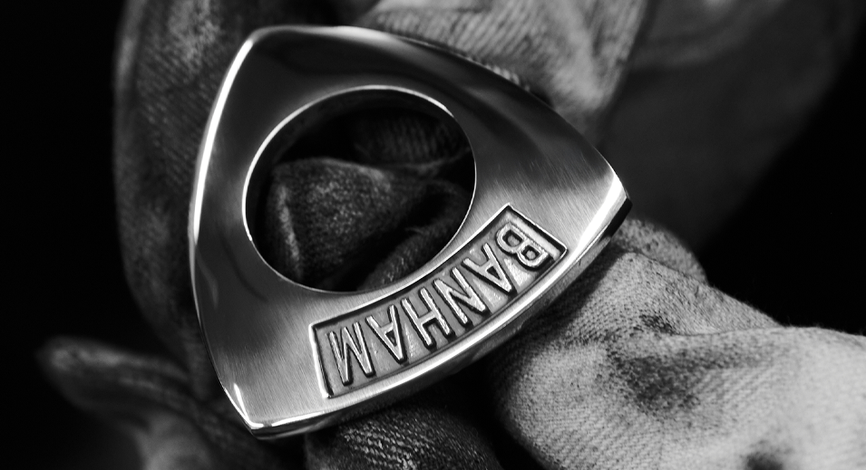 Close-up of a hand holding the iconic Banham lock shield.