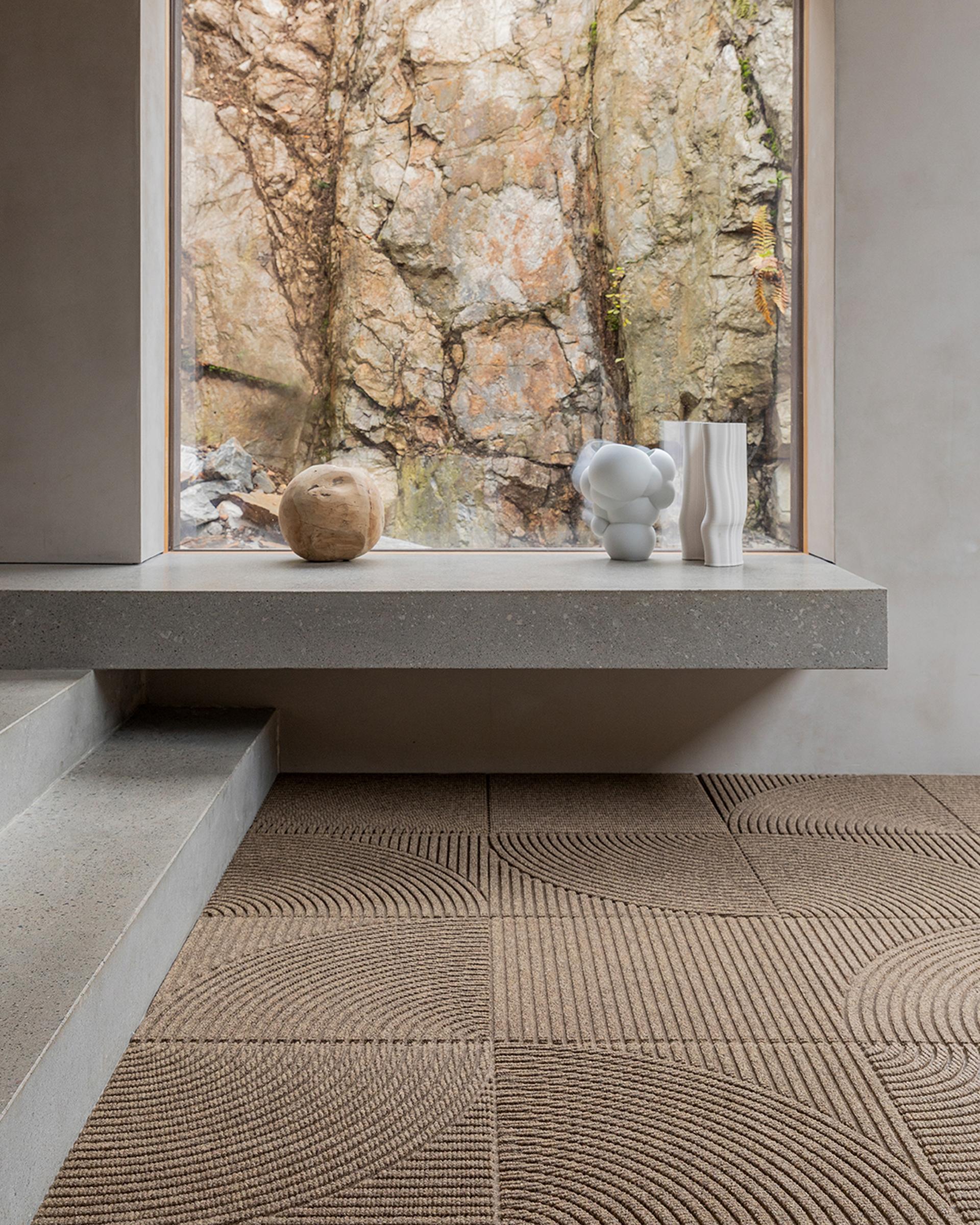 Concrete minimalist home with concrete steps, floor covered in Heymat Entry Mat Tiles