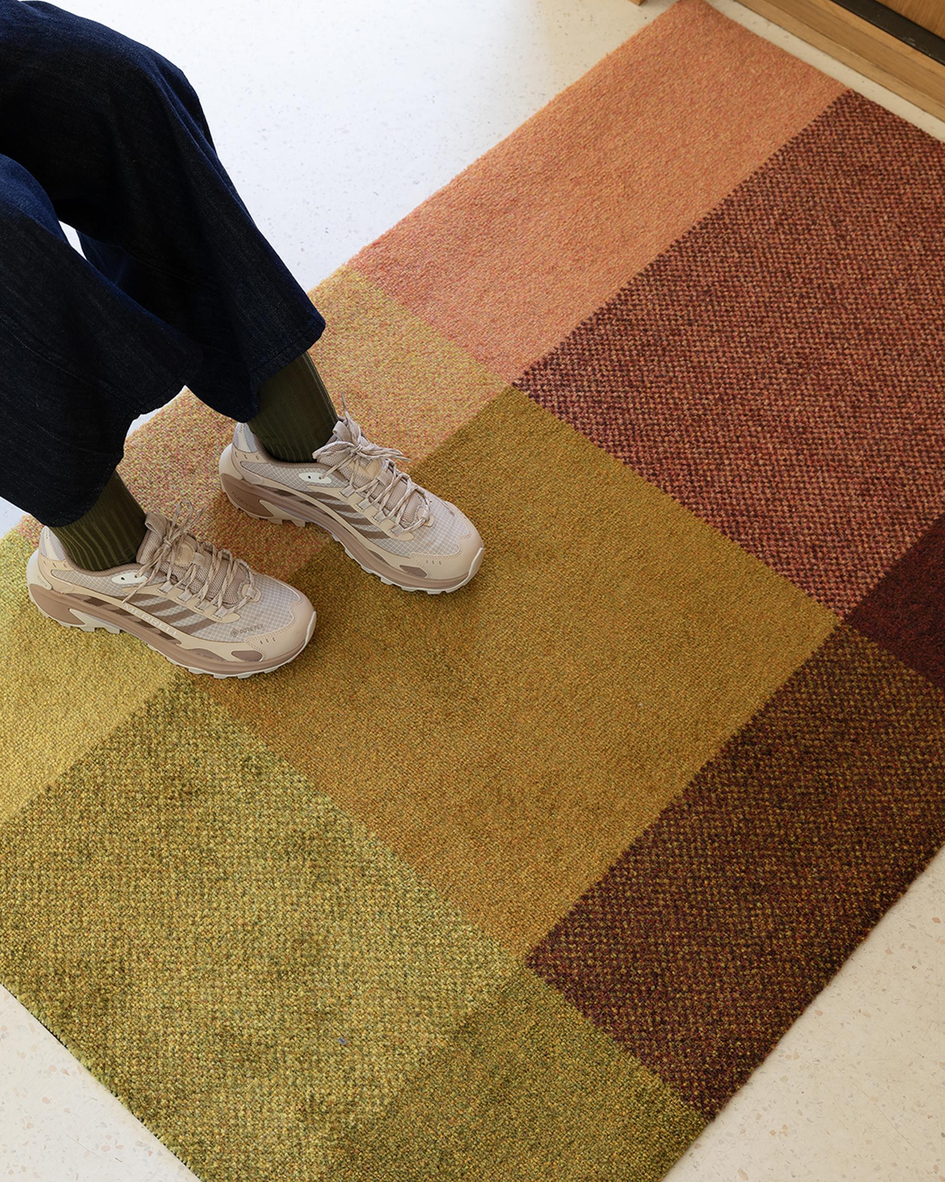 Mix Zest doormat with a person wearing sneakers standing on it