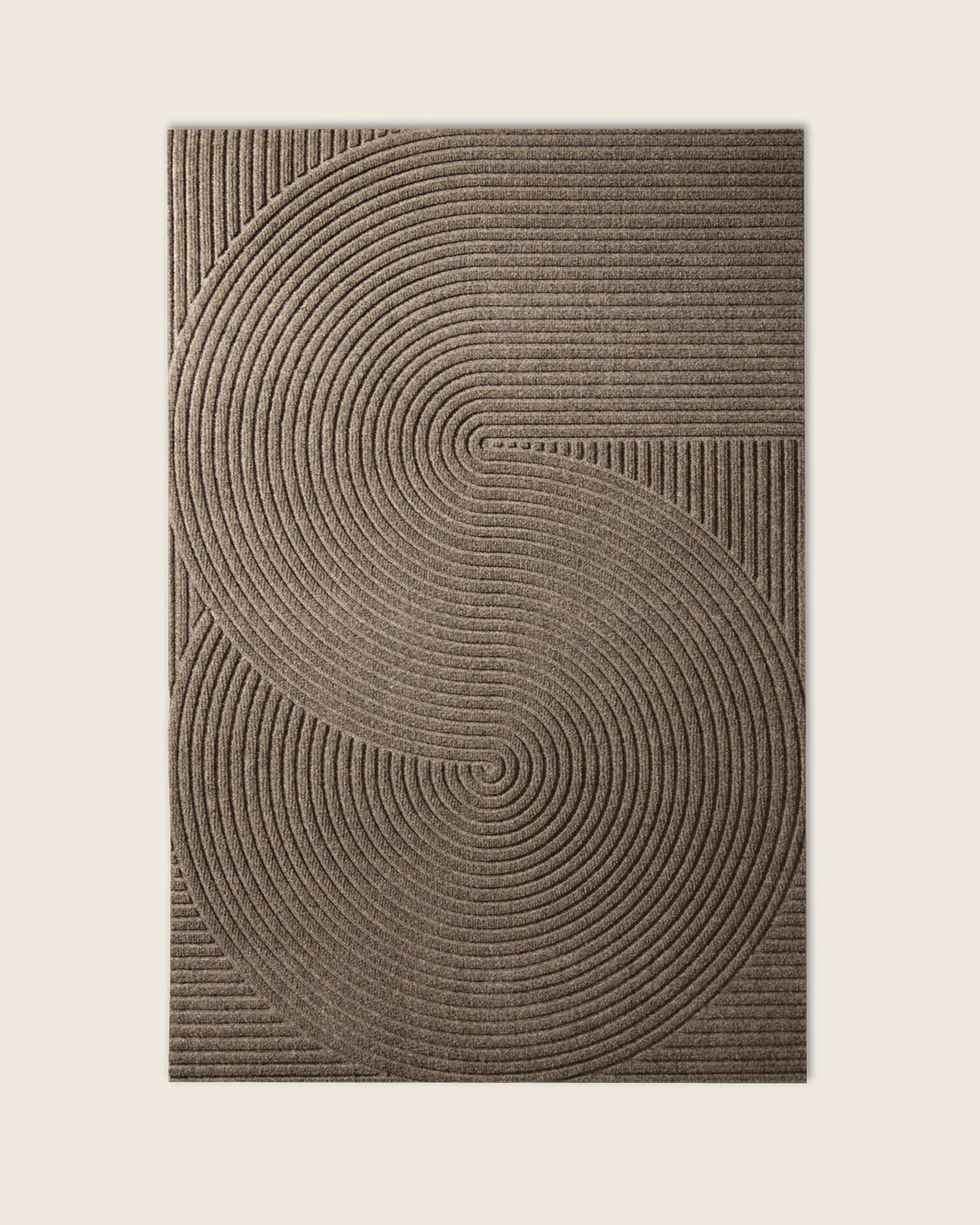 Rectangular doormat with a textured pattern of interlocking curved lines in a spiral design, in a neutral beige color.