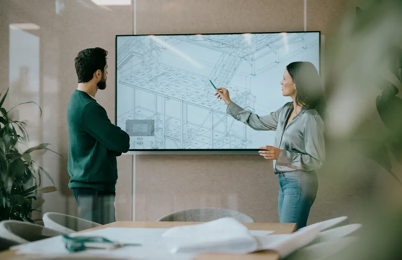 People in meeting with floorplan