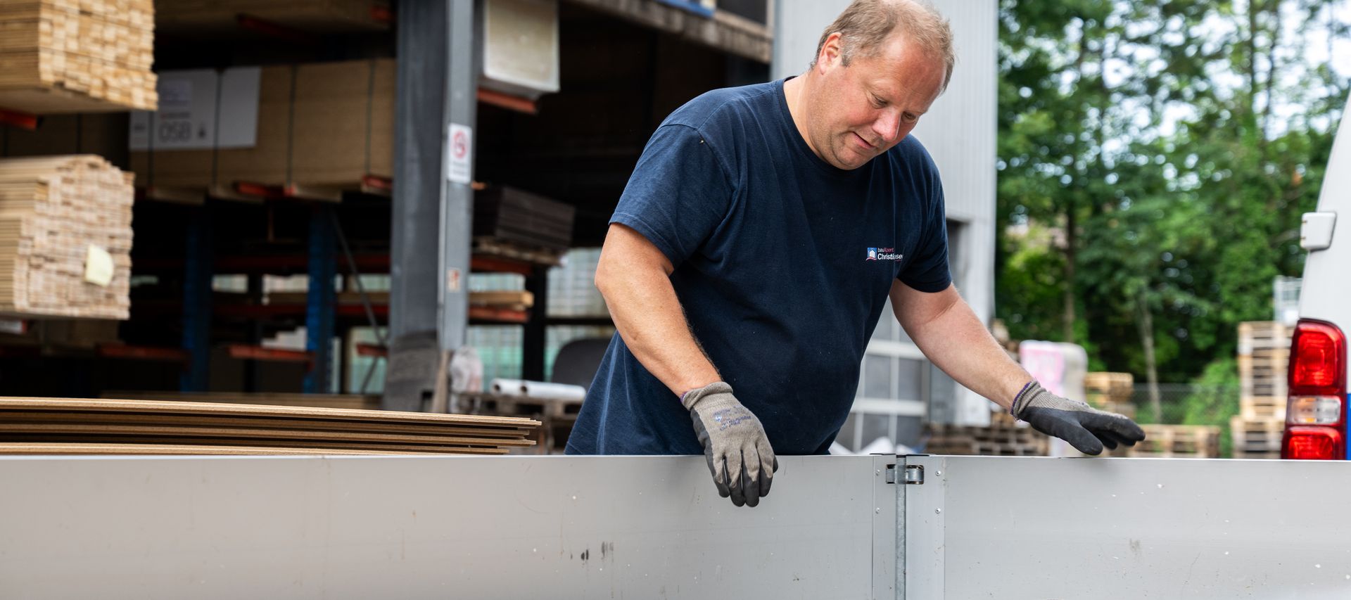 Im Lagerbereich für den Tiefbau sind Holzbalken und Kanthölzer ordentlich gestapelt und für den Abtransport vorbereitet.
