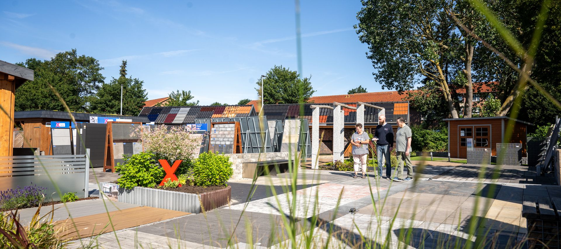 Übersicht der Gartenausstellung von bauXpert Dittmer in Lütjenburg mit Pflasterflächen, Terrassendielen und Sichtschutzelementen
