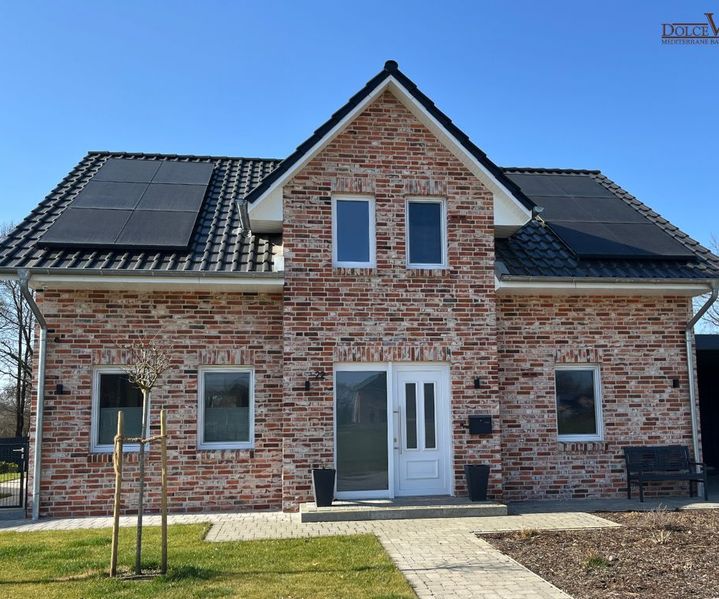 Einfamilienhaus mit weißen Fenstern gebaut mit Ziegelsteinen aus dem Rübau